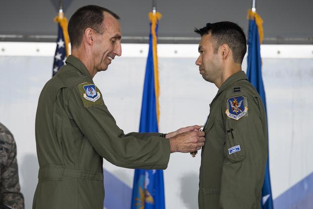 U.S. Air Force Maj. Gen. Scott Zobrist, left, 9th Air Force commander, places a Distinguished Flying Cross medal on Capt. William “Archer” Dana, 74th Fighter Squadron A-10C Thunderbolt II pilot, on May 23, 2018, at Moody Air Force Base, Ga. (U.S. Air Force photo by Senior Airman Janiqua P. Robinson)