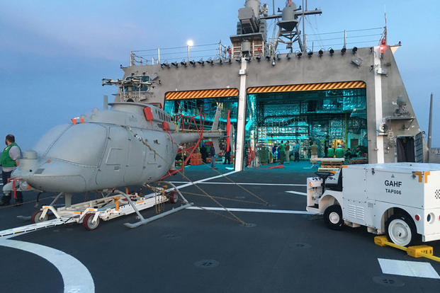 An MQ-8C Fire Scout sits on the deck of USS Montgomery (LCS 8). Montgomery Sailors and the Fire Scout testing team are underway conducting dynamic interface testing to verify the MQ-8C launch and recovery procedures and test interoperability between the unmanned helicopter and the ship. (U.S. Navy photo/Jacob A. Shafer)