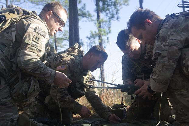 Soldiers assigned to 1st Battalion, 38th Cavalry Regiment, 1st Security Force Assistance Brigade build their communications system during a field training exercise Oct. 24, 2017, at Ft. Benning, Ga. (U.S. Army/Sgt. Arjenis Nunez)