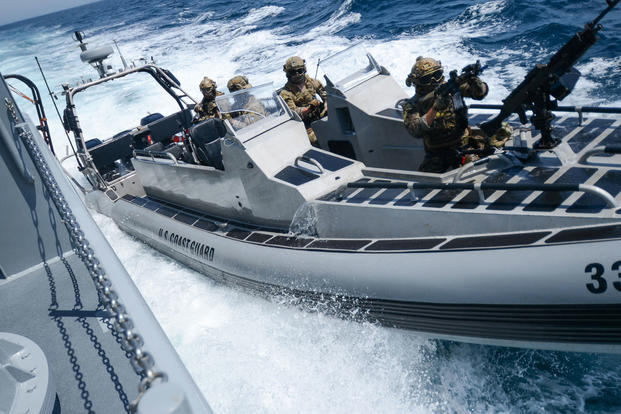 Coast Guard deployable specialized forces with Maritime Security Response Team West and Royal Canadian Navy explosive ordnance disposal technicians assigned to Fleet Diving Unit Pacific conduct maritime interdiction operations training during the force integration phase of Rim of the Pacific Southern California off the coast of San Diego, July 6, 2018. (U.S. Navy photo/Matthew A. Stroup)