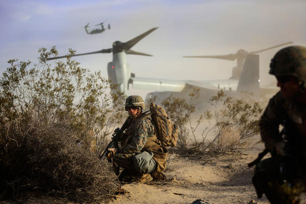 Cpl. Paul Regotti, a squad leader with 3rd Battalion, 7th Marine Regiment, provides security for Marines exiting an MV-22 Osprey during an air assault on a Military Operation on Urbanized Terrain town. The training was part of the Marine Corps' Combat Readiness Evaluation Exercise, Jan. 16, 2015. (U.S. Marine Corps photo/Julio McGraw)