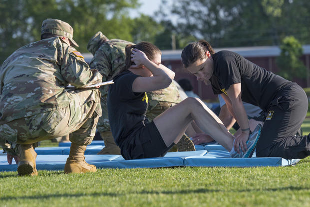 An Army reservist does sit-ups.