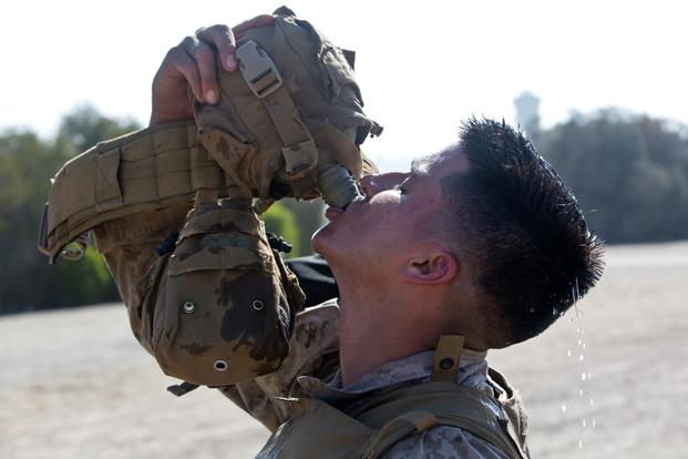 Marine Corps Lance Cpl. Efrain Acevedo with Headquarters Company, Headquarters and Service Battalion (HQSVC BN), Marine Corps Recruit Depot (MCRD) San Diego, drinks water out of his canteen at MCRD San Diego, Calif., June 27, 2016. (Robert G. Gavaldon/U.S. Marine Corps)