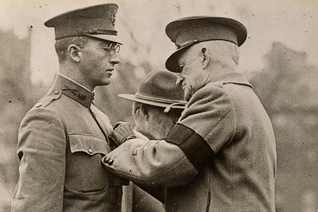 Lt. Col. Charles Whittlesey, the New York lawyer originally from Pittsfield, Massachusetts, who led the "Lost Battalion" of the 77th Division in October 1918, receives the Medal of Honor from General Clarence Edwards during a ceremony on Boston Common on Dec. 30. 1918. Whittlesey, the commander of the 1st Battalion,308th Infantry Regiment took command of his unit and elements of the 2nd Battalion 308th Infantry when they were cut off by German troops in October, 1918. He refused repeated surrender demands a