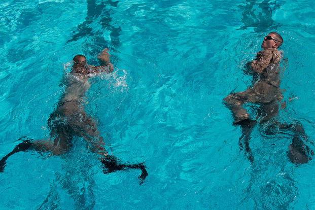 Marines swim with fins during scout swimmers course.
