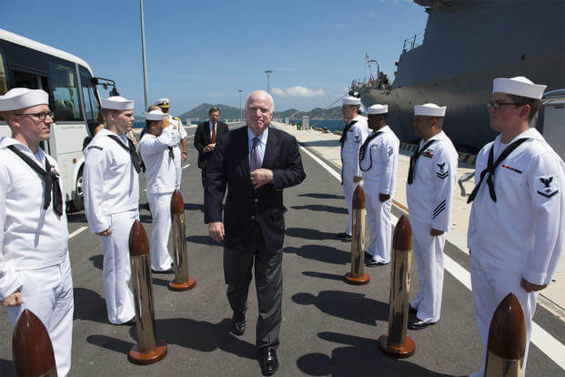 Sen. John S. McCain III is piped aboard during a visit to the Arleigh Burke-class guided-missile destroyer USS John S. McCain
