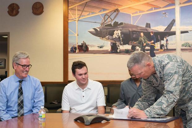 Terry Young, Surprise Police Department police chief, signs the Emergency Vehicle Operators Course Memorandum of Understanding at Luke Air Force Base, Ariz., Jan. 10, 2018. (U.S. Air Force photo/Airman 1st Class Caleb Worpel)