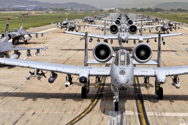 A-10 Thunderbolt IIs and F-16 Fighting Falcons perform an 'elephant walk' on the runway at Osan Air Base, Republic of Korea. The A-10s are the 25th Fighter Squadron "Draggins" and the F-16s are the 36th Fighter Squadron "Fiends" from the 51st Fighter Wing. Additional F-16s are the 179th Fighter Squadron "Bulldogs" from the 148th Fighter Wing out of Duluth Air National Guard Base, Minnesota. (US Air Force photo/Travis Edwards)