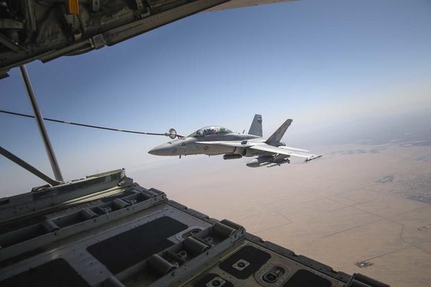 An F/A 18C Hornet connects to the fuel line of a KC-130J Hercules during a fixed-wing air-to-air refueling mission as part of Weapons and Tactics Instructor course 2-15 at Marine Corps Air Station Yuma, Ariz., on April 16, 2015. (Marine Corps Photo by Cpl. Charles Santamaria)
