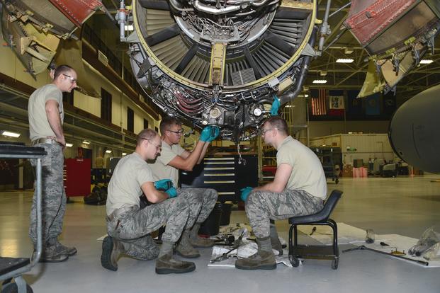 185th Air Refueling Wing jet engine mechanics remove a transfer gear box from a General Electric F-108 engine on a U.S. Air Force KC-135 at the Iowa Air National Guard aircraft maintenance facility in Sioux City, Iowa on January 17, 2019. (U.S. Air National Guard/Senior Master Sgt. Vincent De Groot)