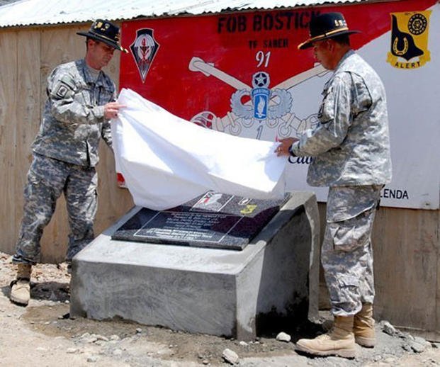 Members of the 173rd Airborne Brigade unveil a plaque and officially name Froward Operating Base Bostick in honor of Maj. Thomas G. Bostick, killed in action in 2007 while commanding Bulldog Troop, 1st Squadron, 91st Cavalry Regiment. (Chris Bradley/Army)
