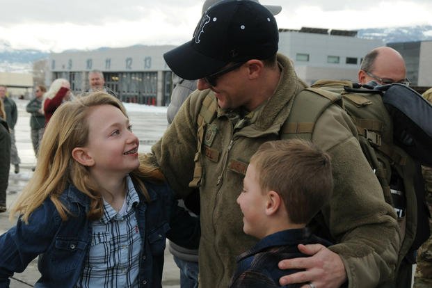 Master Sgt. Krisopher Whetzel, a Nevada Air National Guardsman, is greeted by his kids upon his return from deployment. (US Army/Paul Macomber)