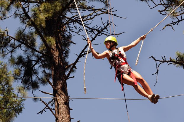 Allie Bashore, camp participant, makes her way across a high-ropes course obstacle during Operation Purple Camp in Cascade, Idaho. (US Air Force/Debbie Lockhart)