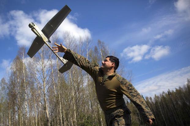 A Navy Corpsman with Marine Rotational Force-Europe 18.1 launches an RQ-11B Small Unmanned Aerial System during Exercise Hedgehog at Paeboja, Estonia, May 3, 2018 (U.S. Marine Corps/Gunnery Sgt. Clinton Firstbrook)
