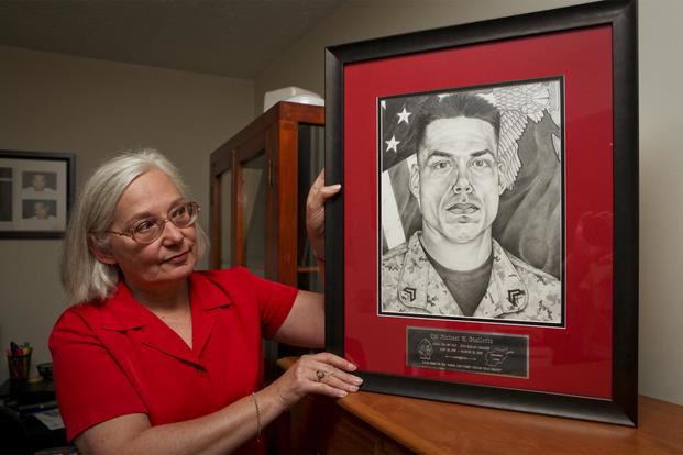 Donna Ouellette, mother of fallen Marine Cpl. Michael W. Ouellette, has a room in her home that honors the memory of her son with plaques, shadow boxes, photographs and a drawing that depicts the fallen squad leader who served with Company L, 3rd Battalion, 8th Marine Regiment. (U.S. Marine Corps/ Sgt. Michael S. Cifuentes)