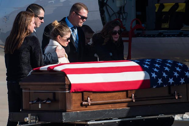 The family of Pfc. Tyler Iubelt react to seeing his coffin during a dignified transfer ceremony Nov. 21, 2016, at Scott Air Force Base, Illinois. (U.S. Air Force photo/Clayton Lenhardt)