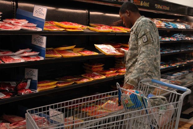 Sgt. Roddrick Johnson of 125th Finance Battalion, 25th Infantry Division, inspects the selection of meat products at the Schofield Barracks commissary. Johnson shops at the post commissary for the sake of convenience and savings. (Photo Credit: Molly Hayden; Staff Writer; U.S. Army Garrison; Hawaii; Public Affairs)
