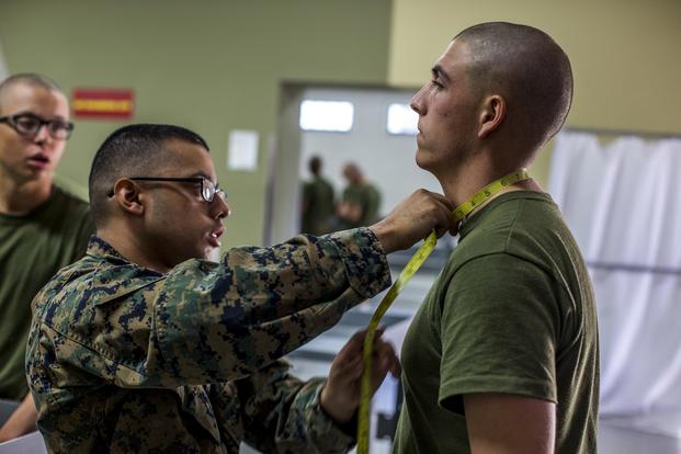 A recruit from Delta Company, 1st Recruit Training Battalion, receives measurements during initial uniform fittings at Marine Corps Recruit Depot San Diego, Nov. 21, 2018. (U.S. Marine Corps/ Lance Cpl. Jose Gonzalez)