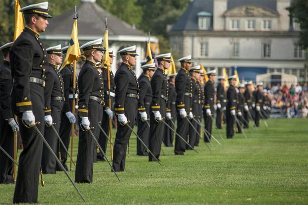Midshipmen with the U.S. Naval Academy (USNA) stand at parade rest during the Second Class Parents Weekend Formal Dress Parade at the USNA, Annapolis, Md. (U.S. Marine Corps/Cpl. Samantha K. Braun)