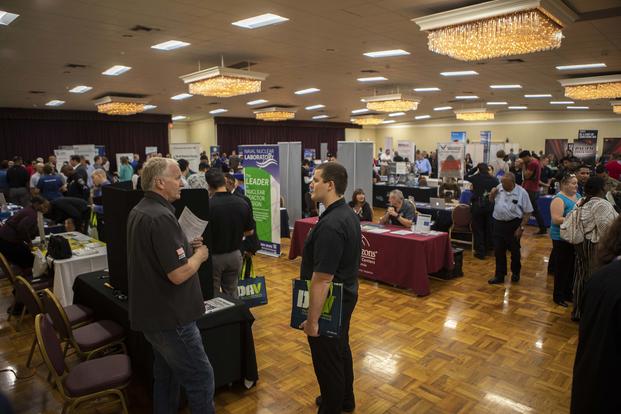 Veterans and service members speak with business representatives about job opportunities at the Recruit Military Job Fair in San Diego on July 11, 2019. (U.S. Marine Corps photo by Sgt. Jake McClung)