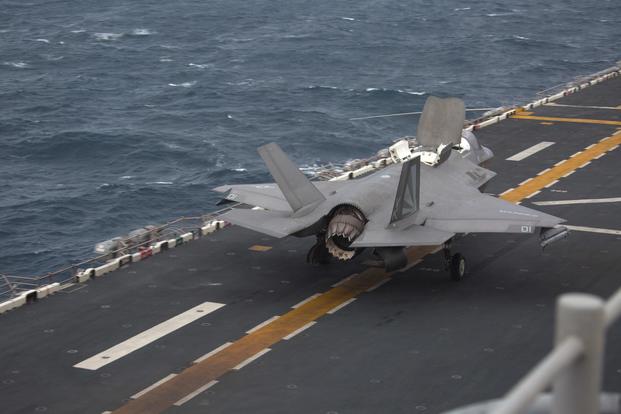 An F-35B Lightning II fighter aircraft, armed with a GAU-22 cannon loaded with high explosive incendiary tracer 25mm rounds, prepares to take off during an aerial gunnery and ordnance hot-reloading exercise aboard the USS Wasp, Solomon Sea, August 4, 2019. (U.S. Marine Corps/Lance Cpl. Dylan Hess)