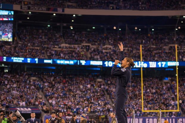 Air Force Tech. Sgt. Nalani Quintello, lead singer of the Air Force rock band Max Impact, performs in front of thousands of NFL fans at MetLife Stadium in East Rutherford, N.J., Nov. 15, 2015. (U.S. Air Force/ Kevin Burns)