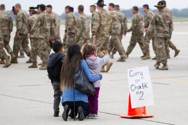 Children wave goodbye to cavalry troopers from the 1st Squadron, 18th Cavalry Regiment, California National Guard, as the unit departs. (Air National Guard/Crystal Housman)