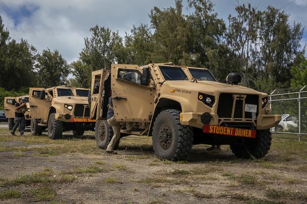 U.S. Marines with 3d Marine Regiment and Joint Light Tactical Vehicle (JLTV) instructors enter JLTV's during a JLTV field training exercise, Marine Corps Training Area Bellows, July 29, 2019. (U.S. Marine Corps/Cpl. Matthew Kirk)