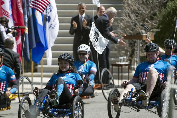 President Barack Obama applauds wounded warrior cyclists at the White House in Washington, April 16, 2015. Wounded veterans from each service rode their cycles around the White House as part of the Wounded Warrior Project Annual Soldier Ride. (DoD/EJ Hersom)