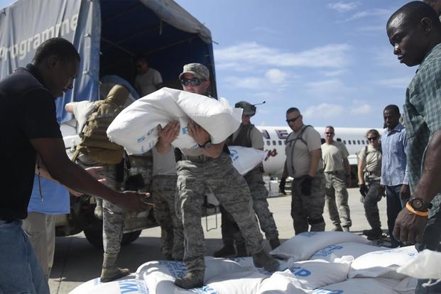Staff Sgt. Angelo Morino, 621st Contingency Response Wing, transports food and provisions for Hurricane victims, October 9th, 2016, Port-Au-Prince, Haiti.(U.S. Air Force/Staff Sgt. Robert Waggoner)