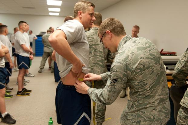 Senior Airman Chris Barrier from the 124th Security Forces Squadron get his waist measurement during his annual fitness assessment, Gowen Field, Idaho, April 11, 2015. (Air National Guard/Senior Airman Cassie Morlock)