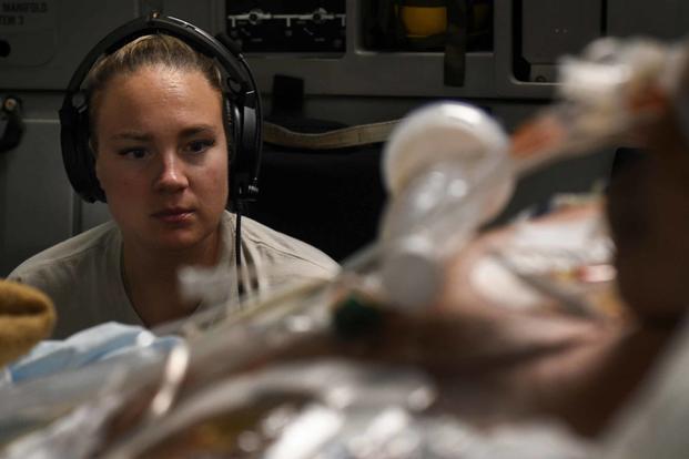 Capt. Natasha Cardinal, 86th Aeromedical Evacuation Squadron critical care nurse, monitors her patient during a flight from Bagram Airfield, Afghanistan, to San Antonio on Aug. 18, 2019. Critical care air transport teams are rapidly deployable teams consisting of a physician, critical care nurse and a respiratory therapist who provide a mobile intensive care unit for complex, critically wounded patients. (U.S. Air Force photo by Airman 1st Class Ryan Mancuso)