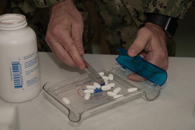 FILE PHOTO -- A Naval reservist counts medicine tablets June 13, 2019, during the IRT at Ballard Memorial High School in Barlow, Ky.  (U.S. Air National Guard/Senior Airman Sarah M. McClanahan)