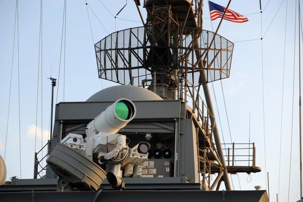 The Afloat Forward Staging Base (Interim) USS Ponce (ASB(I) 15) conducts an operational demonstration of the Office of Naval Research (ONR)-sponsored Laser Weapon System (LaWS) while deployed to the Arabian Gulf. (U.S. Navy/John F. Williams)