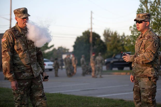 Sgt. 1st Class Bryson Briles (left) and Staff Sgt. Jorge Flechas enjoy a relaxing moment vaping before heading to class at U.S. Army Recruiting and Retention College Sept. 5, 2019. Briles said he vapes as a safer alternative to cigarettes. Flechas said he vapes for recreational purposes. Health officials say they suspect the more than 200 recent deaths and serious illnesses across a 15-state area in the United States are the result of vaping. (Eric Pilgrim/Army)