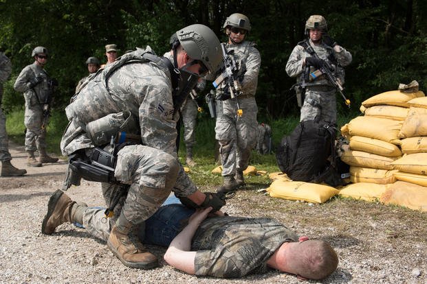 An airman arrests a suspect during an exercise. 