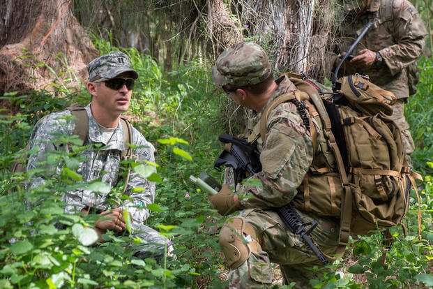 Capt. Darren Guree and Sgt. 1st Class Bryan Dennis of 112th Signal Batt. (Special Operations) (Airborne) - Special Operations Command Pacific, Signal Support Det, discuss the team's progress during Hammerhead Field Training Exercise/Situational Training Exercise 17-2, March 30, 2017. Capt. Darren Guree, left, is wearing the pixelated Universal Camouflage Pattern uniform. (U.S. Navy photo/Cynthia Z. De Leon)