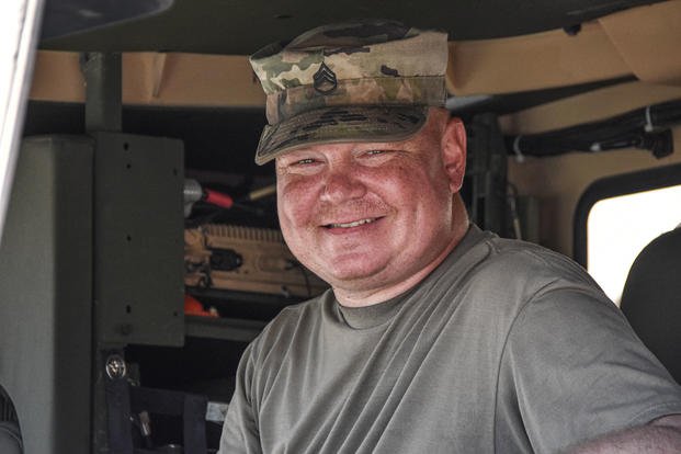 A member of the National Guard drives a truck. 