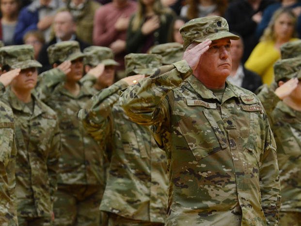 Oregon National Guard members salute.
