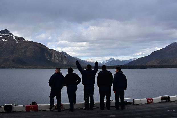 Sailors observe the Andes Mountains.