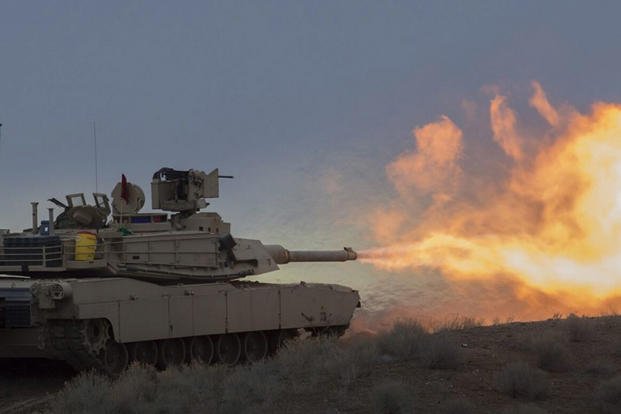 M1A2 Abrams Tanks fire during an exercise.