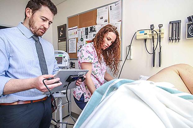 Researcher Dr. Matthew Peterson and nurse Trina Dickert measure bedsores, or pressure ulcers, a common problem for veterans with spinal cord injury, as well as other patient populations. (Photo by Dan Henry via VA.org)