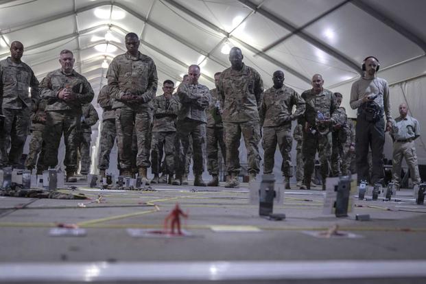 Lt. Gen. R. Scott Dingle, the Surgeon General of the U.S. Army, receives a sand table briefing in the exercise control tent at Sierra Army Depot, California, during the United States Forces Command Medical Emergency Deployment Readiness Exercise Distinguished Visitor Day, Nov. 4, 2019. (U.S. Army Forces Command/ Spc. ShaTyra Reed)