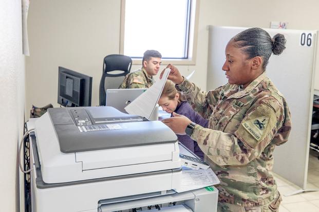 A soldier photocopies tax documents at the Fort Bliss Tax Center. 