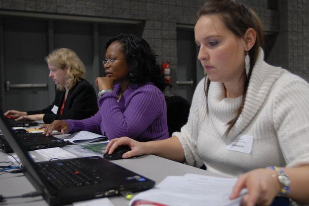 Military spouses at a career expo working on skills training