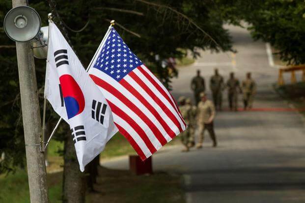 The South Korean and American flags fly next to each other at Yongin, South Korea. 