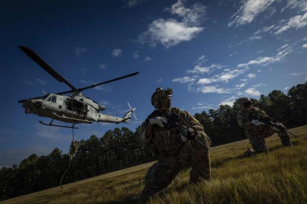 Special Warfare Airmen fast rope from a UH-1Y Venom helicopter.