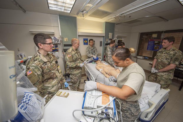 Army and Air Force doctors assess a simulated trauma patient at Brooke Army Medical Center