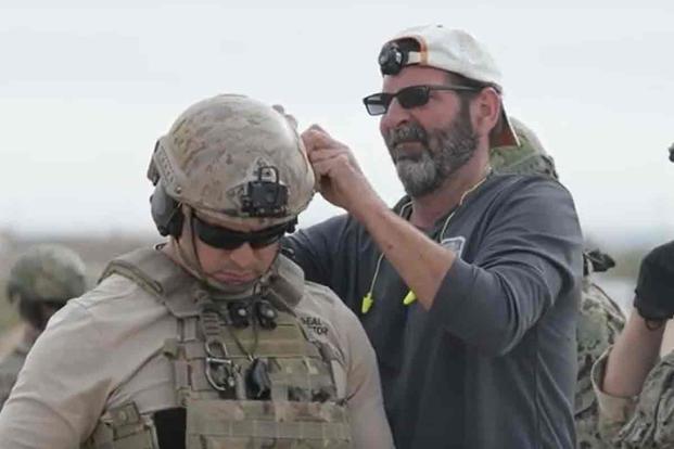 A member of the Neuro Tactical Research Team fits a sensor on a U.S. Navy SEAL