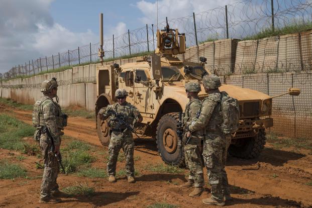 U.S. Army Soldiers discuss security patrol operations during a security patrol stop in Somalia.
